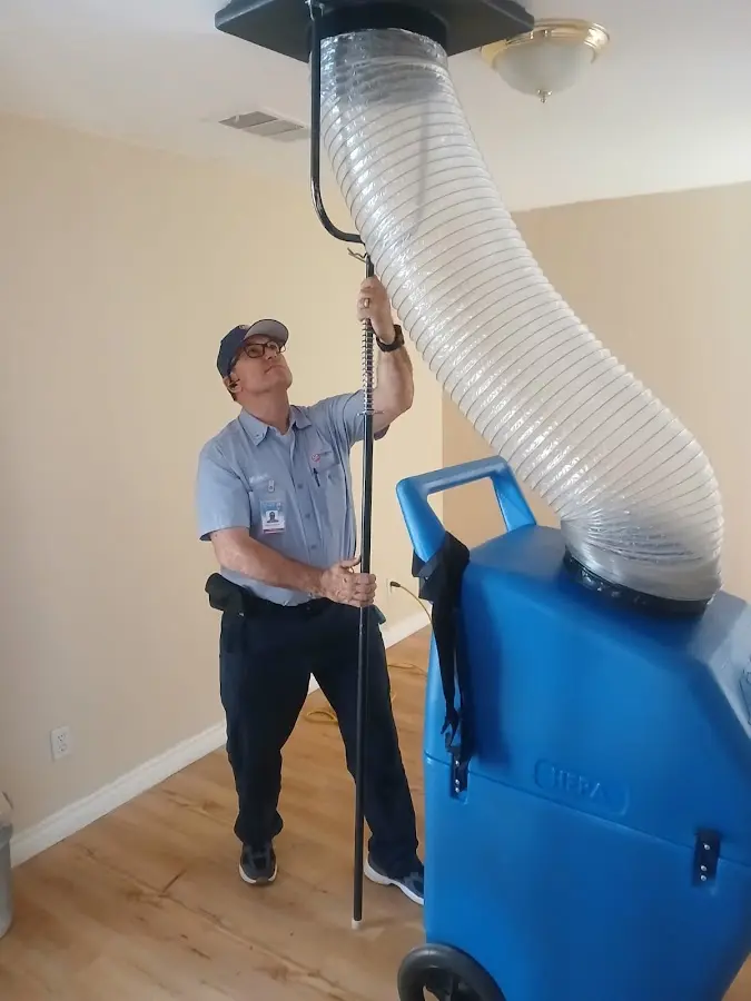 Furnace Tune-Up technician using HEPA equipment in Worth